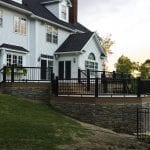 patio featuring custom stone work, custom flared steps, and a poolside area