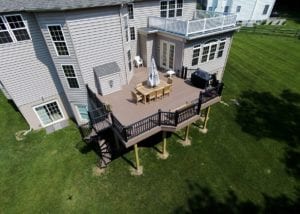 deck with a spiral staircase and post cap lighting