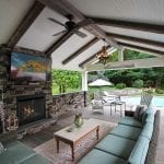 Manning - Timbertech deck and porch with barnwood and stonework fireplace