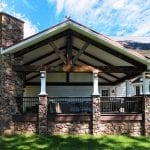 Polizzi - Trex Deck and porch with stonework and barnwood beams