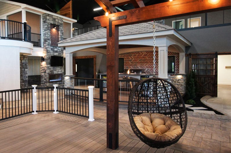 keystone custom decks inspiration center featuring pergola with hanging egg chair