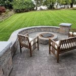 Stamped concrete patio with techo bloc sitting wall and fire pit in west chester pa