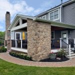 Berghuis - mocha, pecan, and tigerwood Timbertech deck with porch with stone work