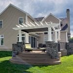 Koloseike - Timbertech pecan deck with provia terra cut slate stone veneer