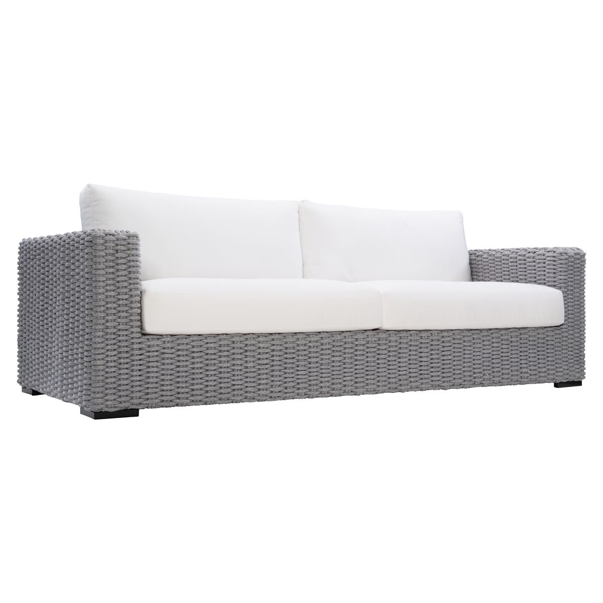 A gray wicker outdoor sofa with white cushions and armrests viewed from the front-left angle on a white background.