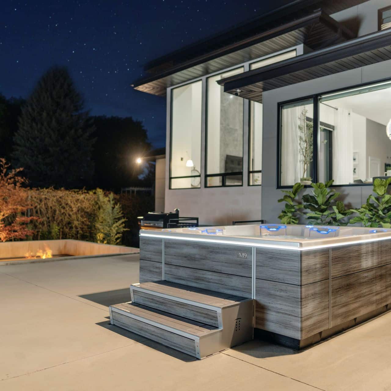 hot tub at nighttime on a back patio