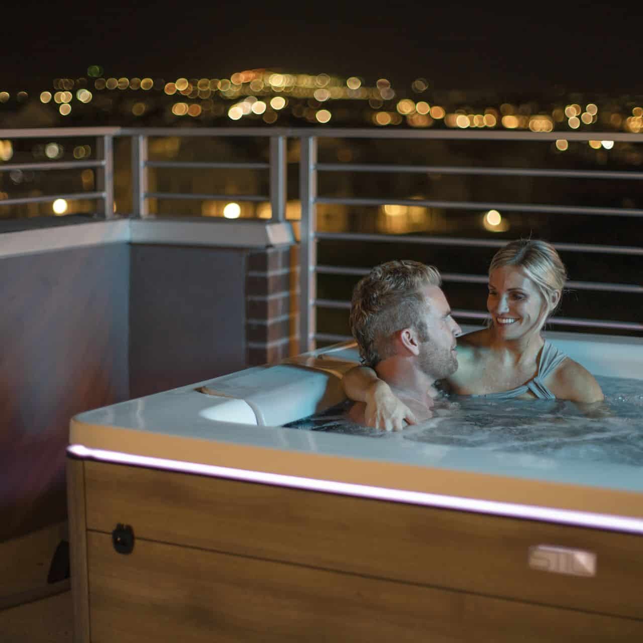 romantic couple in a hot tub at night